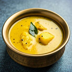 Kerala Kalan yogurt curry with yam and raw banana served in a traditional bowl