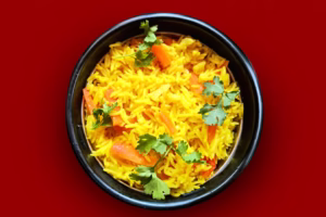 Healthy lunch box rice with colorful vegetables and ghee in a bowl