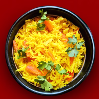 Healthy lunch box rice with colorful vegetables and ghee in a bowl