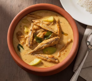 Kerala style dry anchovy curry with coconut and raw mango served with white rice